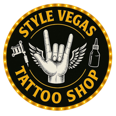 Style Vegas Tattoo Shop logo: Black, gold, and white. Features a hand with rock on gesture and wings, tattoo gun, ink bottle.