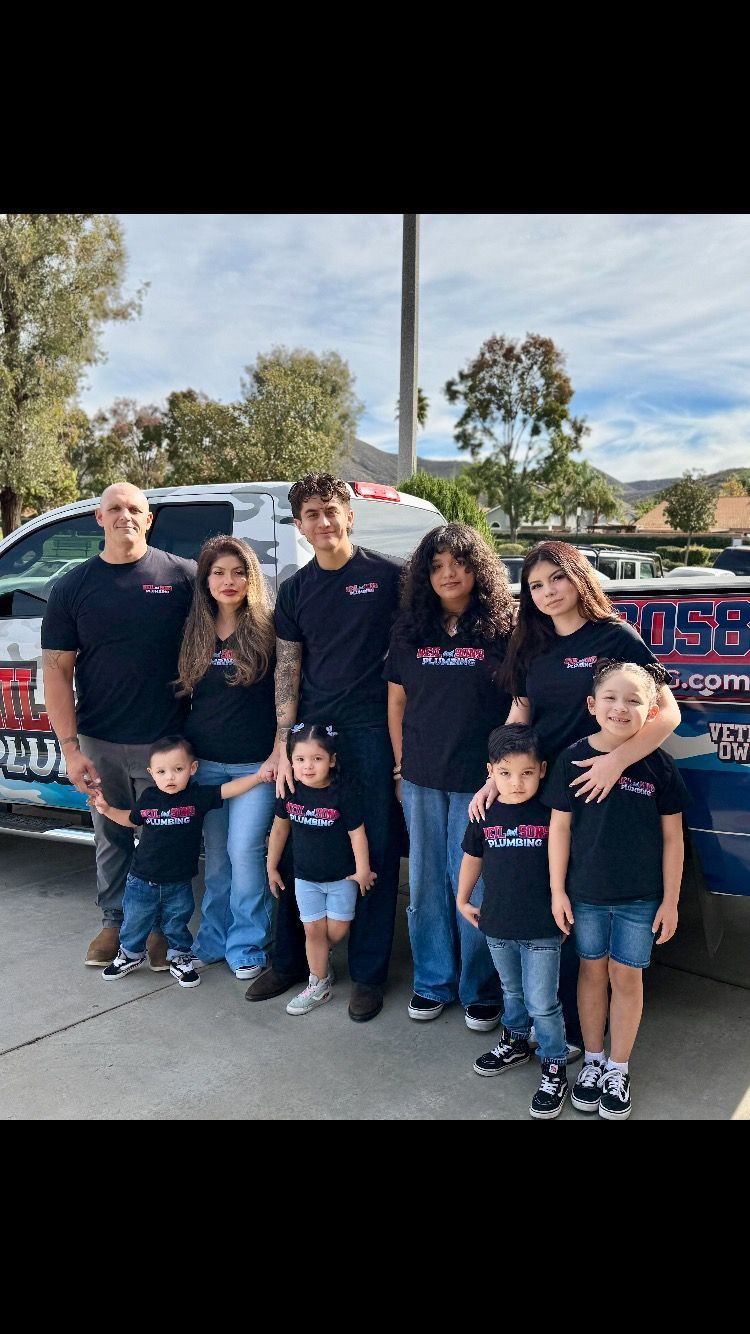 Group of people wearing matching shirts poses near an ambulance.
