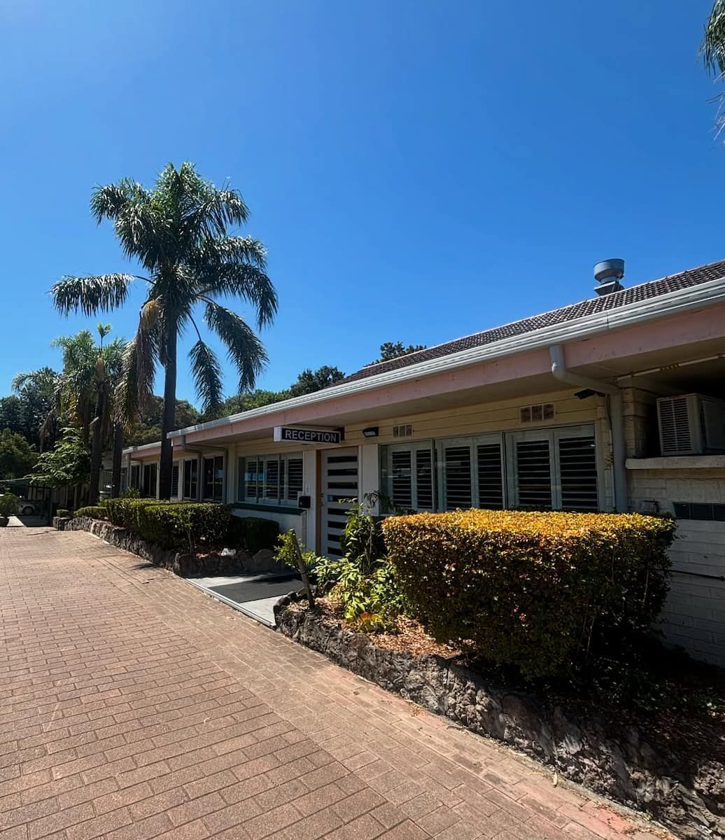 Low-rise Building With a Brick Walkway — Crystal Clear Plumbing & Roofing in Wollongong, NSW