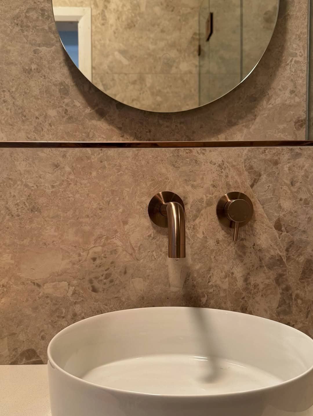 A Modern Bathroom Vanity With a White Vessel Sink, Gold Wall-mounted Faucet — Crystal Clear Plumbing & Roofing in Dapto, NSW