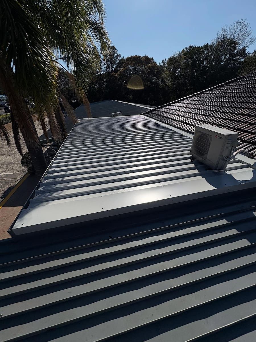 A Grey Metal Corrugated Roof Section — Crystal Clear Plumbing & Roofing in Wollongong, NSW