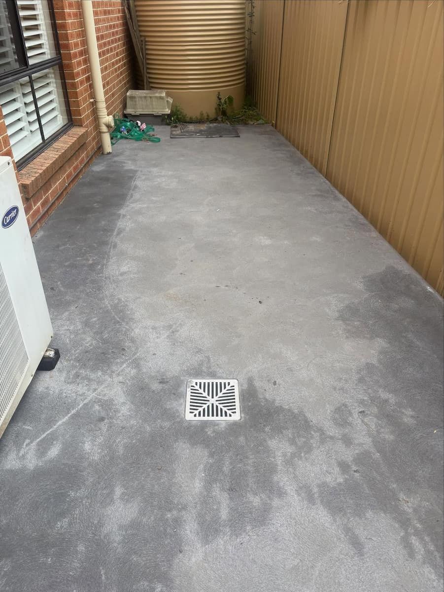 A Narrow Concrete Side Yard With a Central Storm Drain — Crystal Clear Plumbing & Roofing in Wollongong, NSW