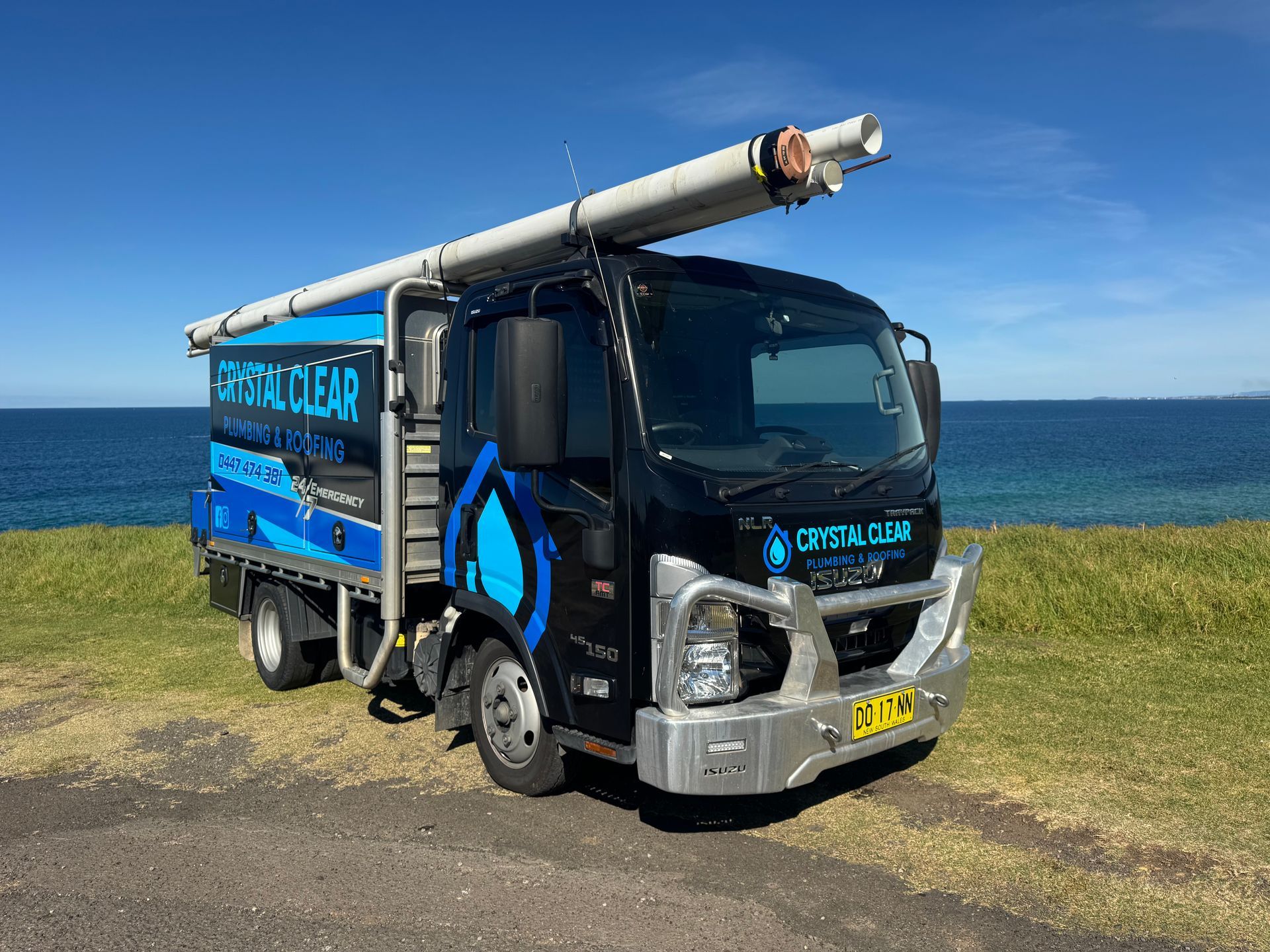 Pickup truck with CRYSTAL CLEAR plumbing sign and blue phone number on the rear — Crystal Clear Plumbing & Roofing in Wollongong, NSW