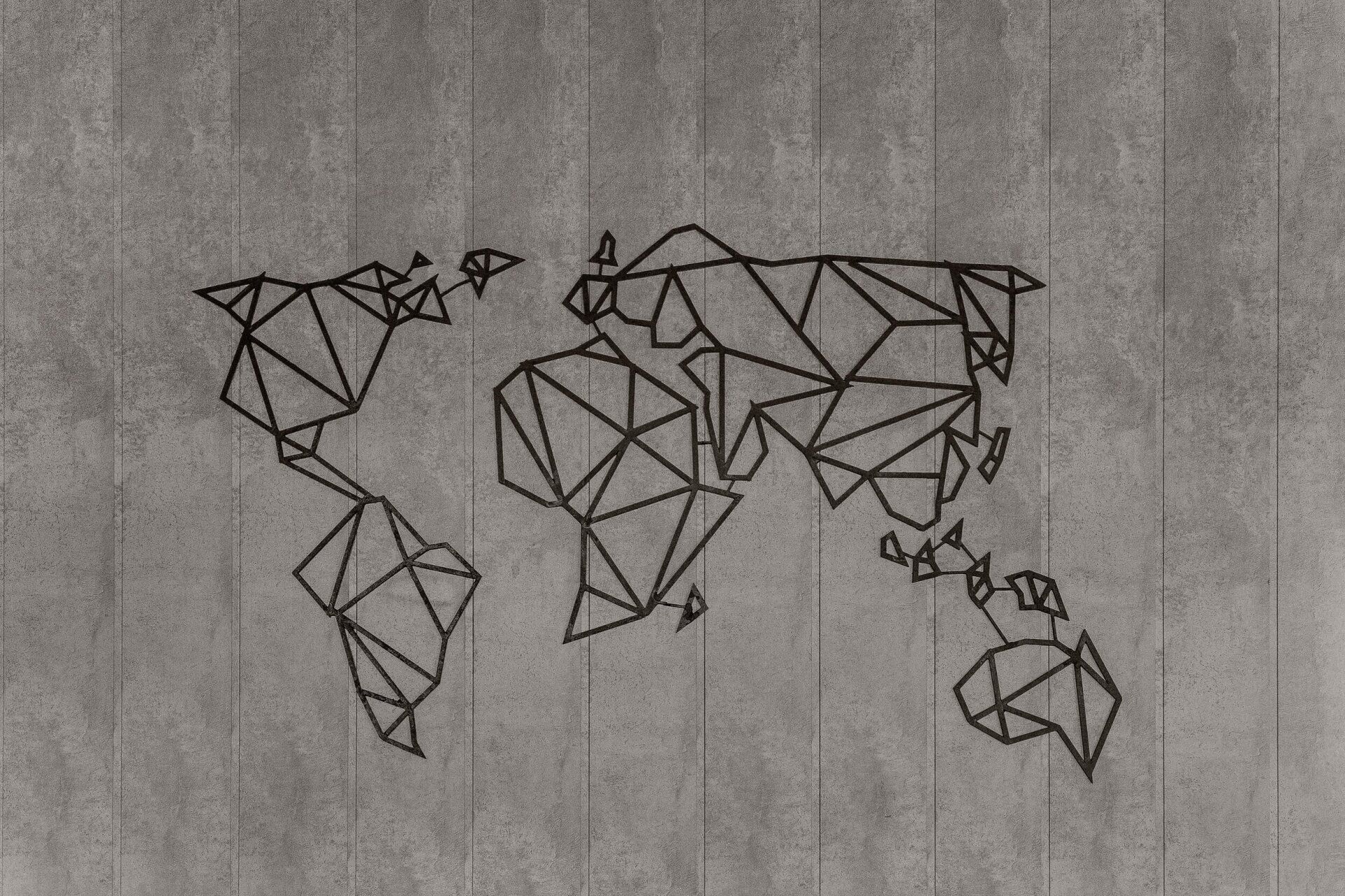 a geometric map of the world is on a concrete wall .