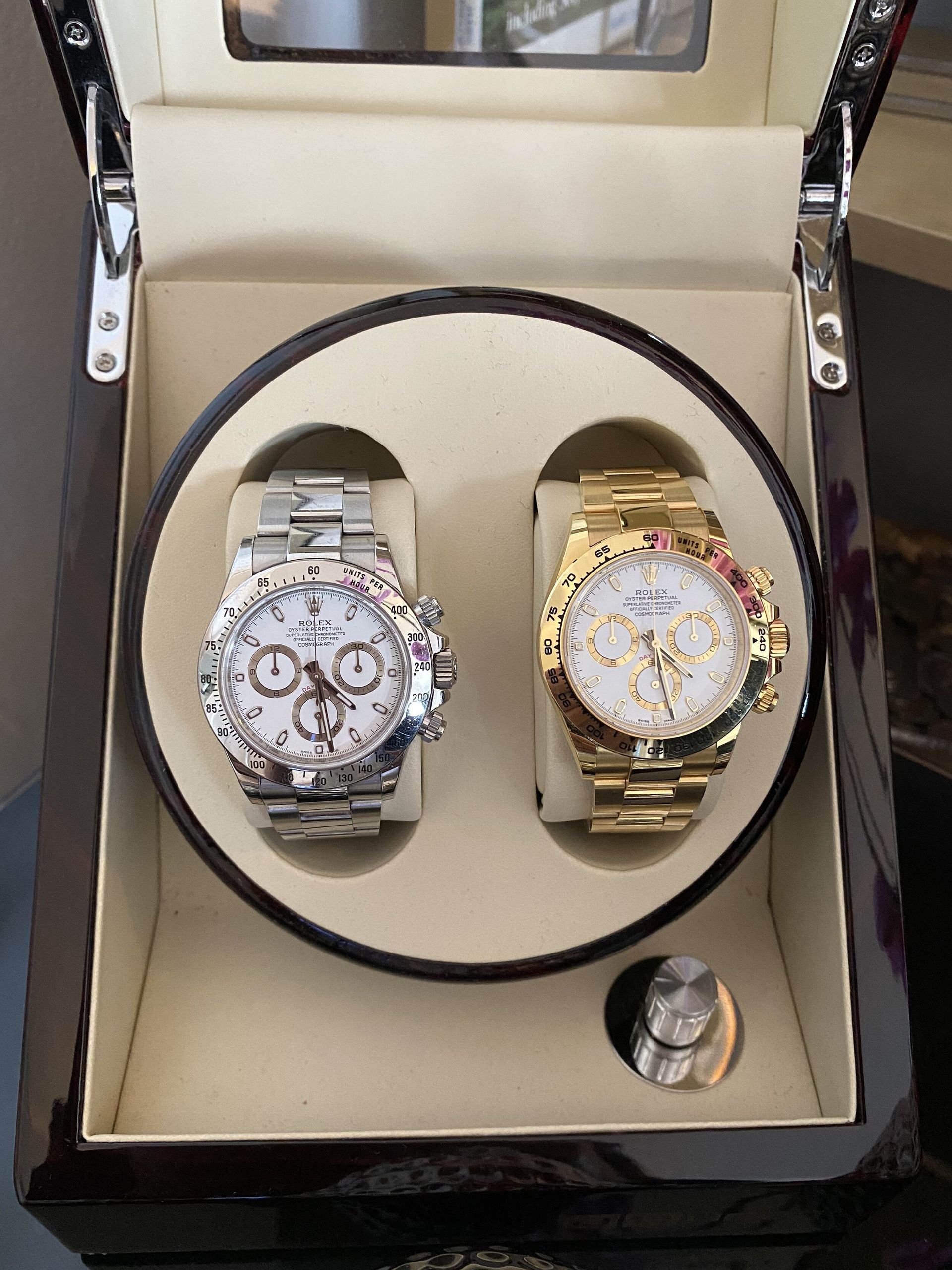 two watches are sitting in a watch box on a table
