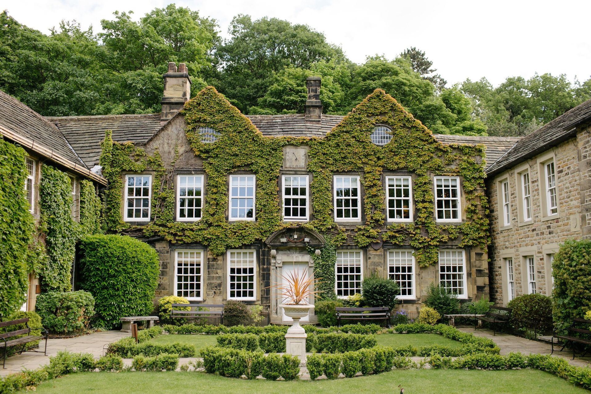 a large stone house with a garden in front of it .
