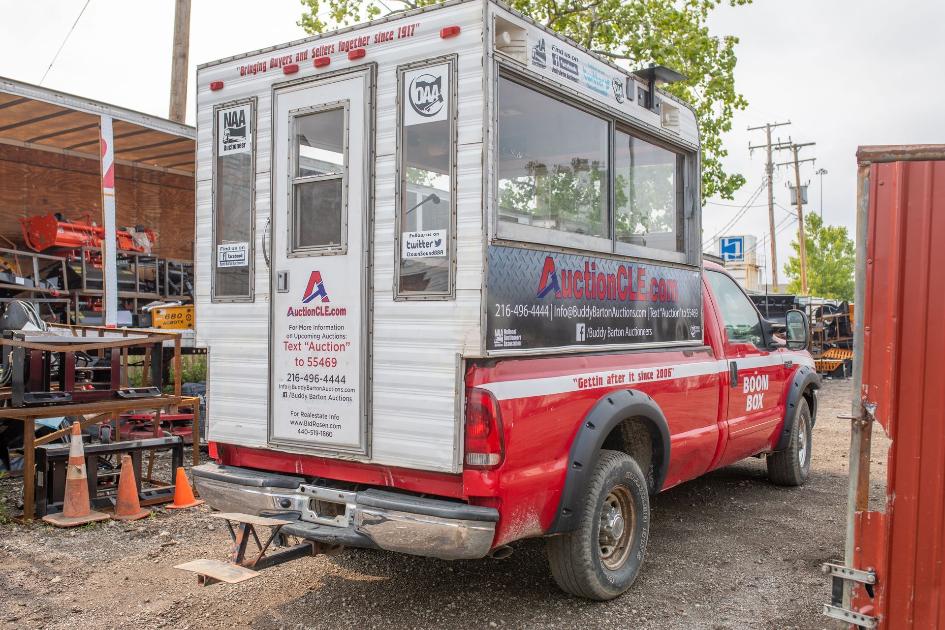Red pickup truck with a white and black service body.