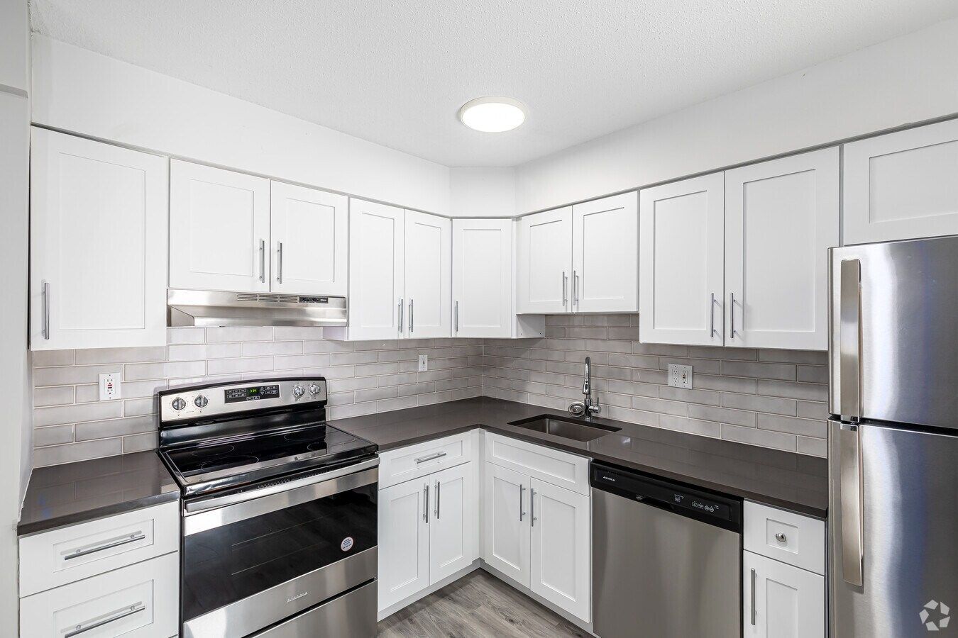 Renovated apartment kitchen with stainless steel appliances at Avon Woods