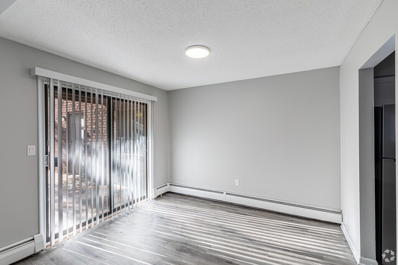 Dining area with sliding door in a two-bedroom Avon Woods apartment