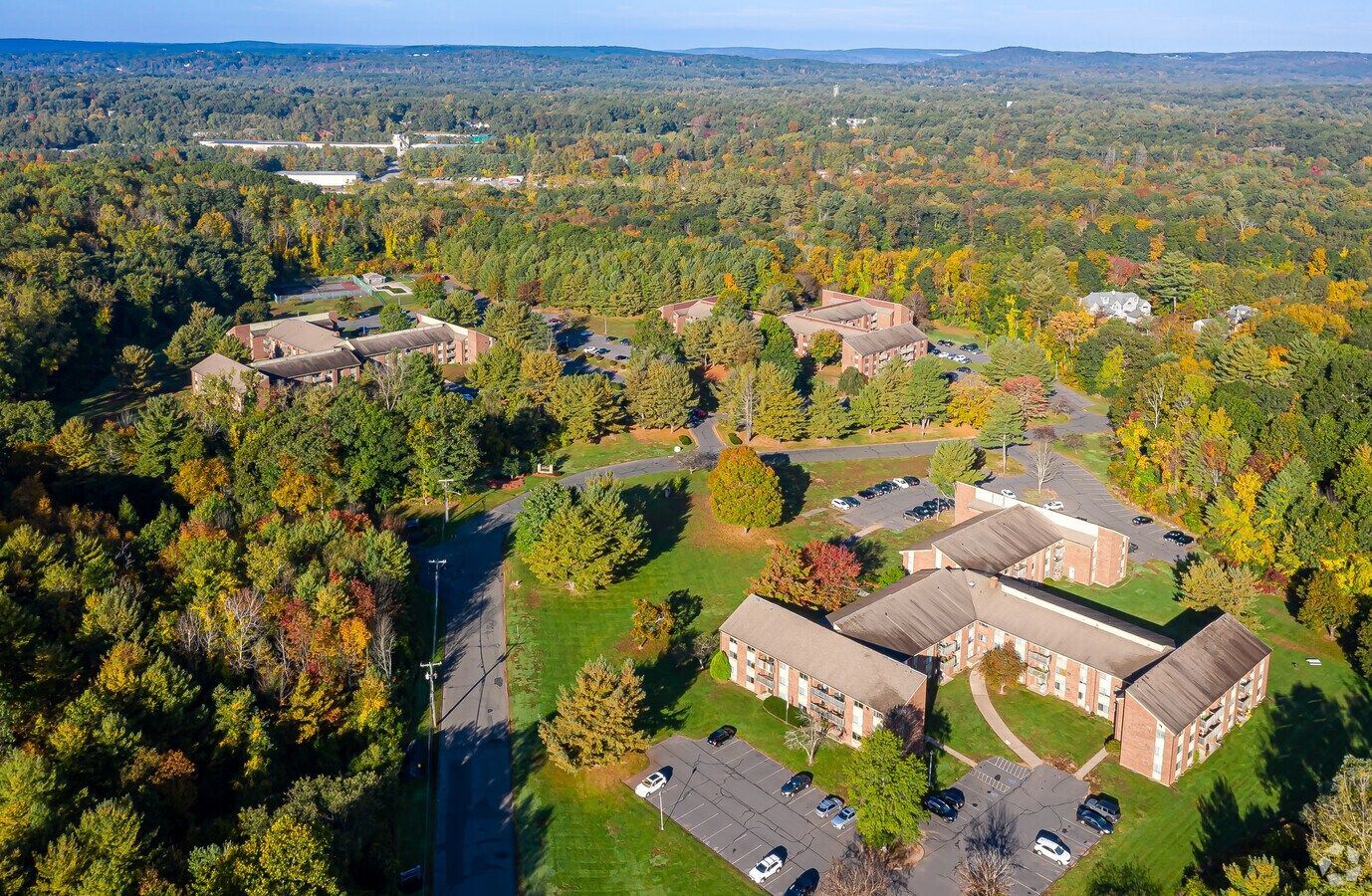 Aerial view of Avon Woods Apartments and surrounding wooded area in Avon, Connecticut
