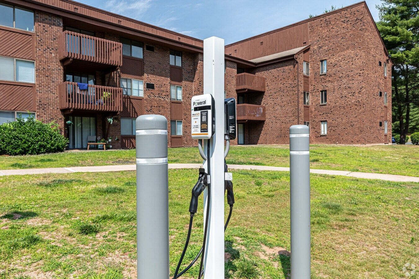 Exterior view of Avon Woods apartment building EV charging station
