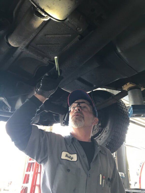 Mechanic checking the car condition — State Inspections in Harrisburg, PA
