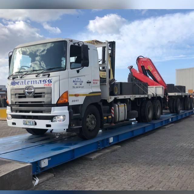 A scalemass truck is sitting on a blue scale