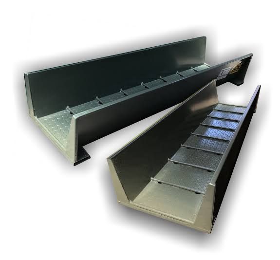 A couple of metal tubes sitting on top of each other on a white surface.