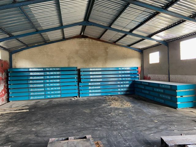 A warehouse with a lot of blue boxes stacked on top of each other