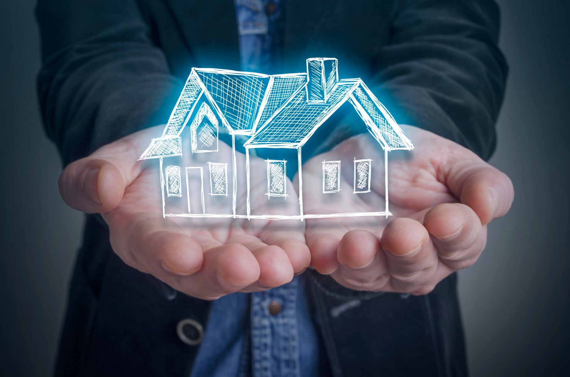 A man holds a house in his hands, symbolizing homeownership in Palm Springs, CA. Liberty Escrow INC 