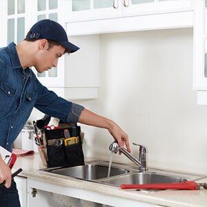 Man inspecting faucet problem — commercial plumbing in Stuart, FL