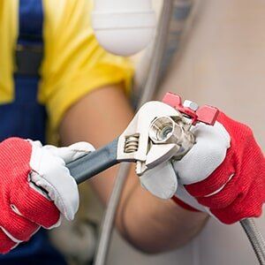 Man adjusting pipeline — plumbing services in Stuart, FLMan adjusting pipeline — plumbing services in Stuart, FL