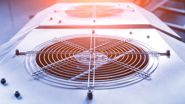 A close up of a fan on top of a machine.