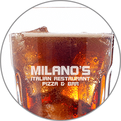 A close up of a glass of milano 's italian restaurant pizza and bar