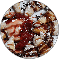 A close up of a plate of food with sauce and powdered sugar.