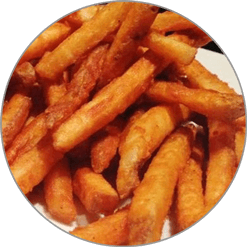 A close up of a plate of french fries on a table.