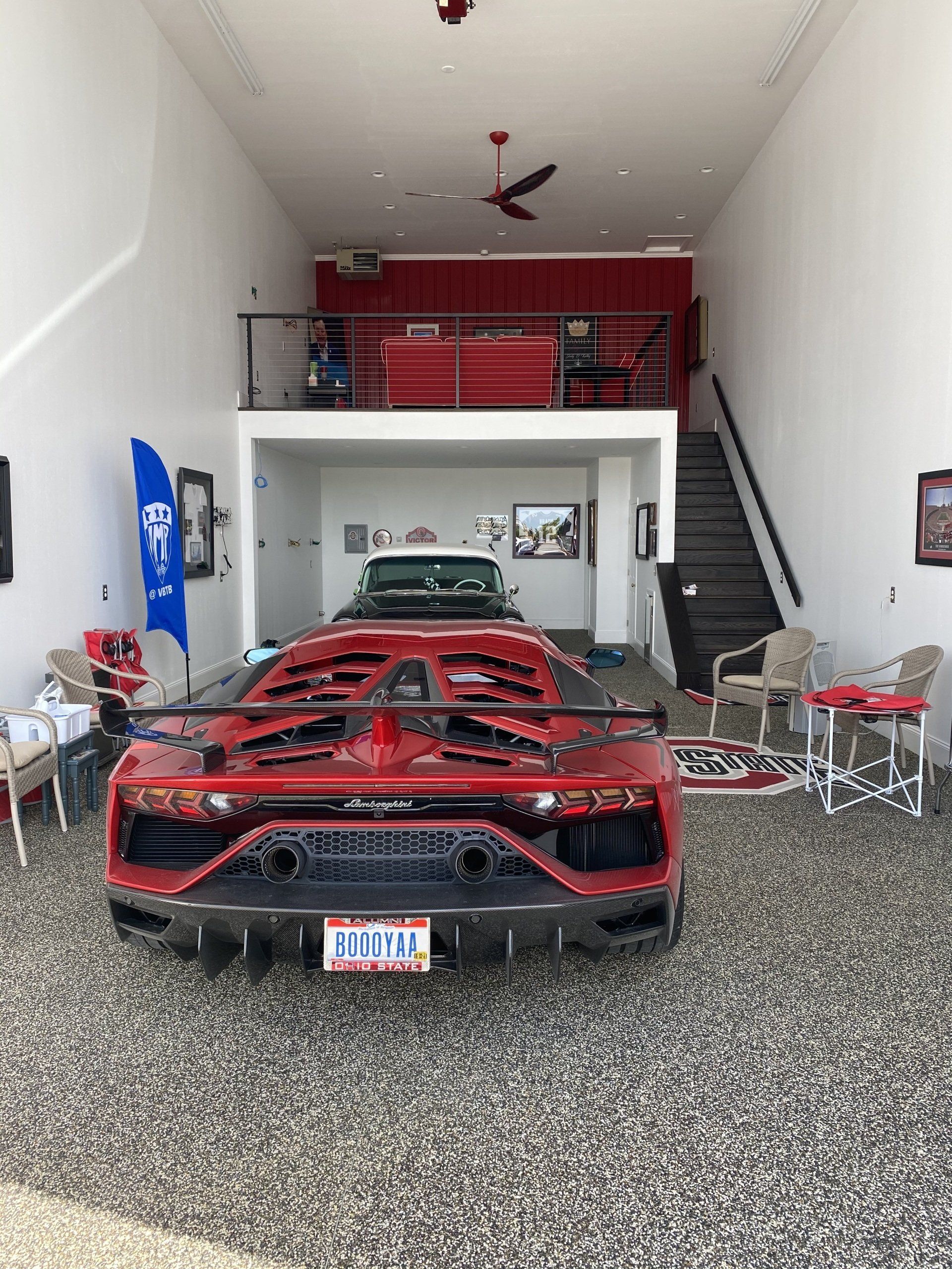 a red sports car is parked in a garage with a california license plate