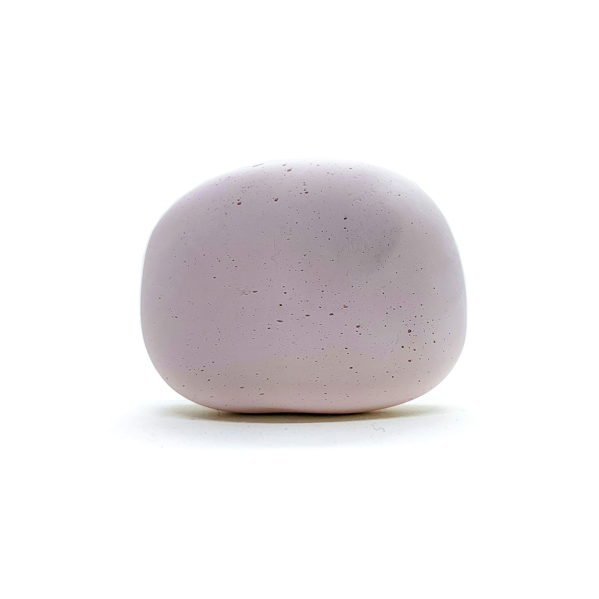 Light purple, rounded decorative stone against a white background.