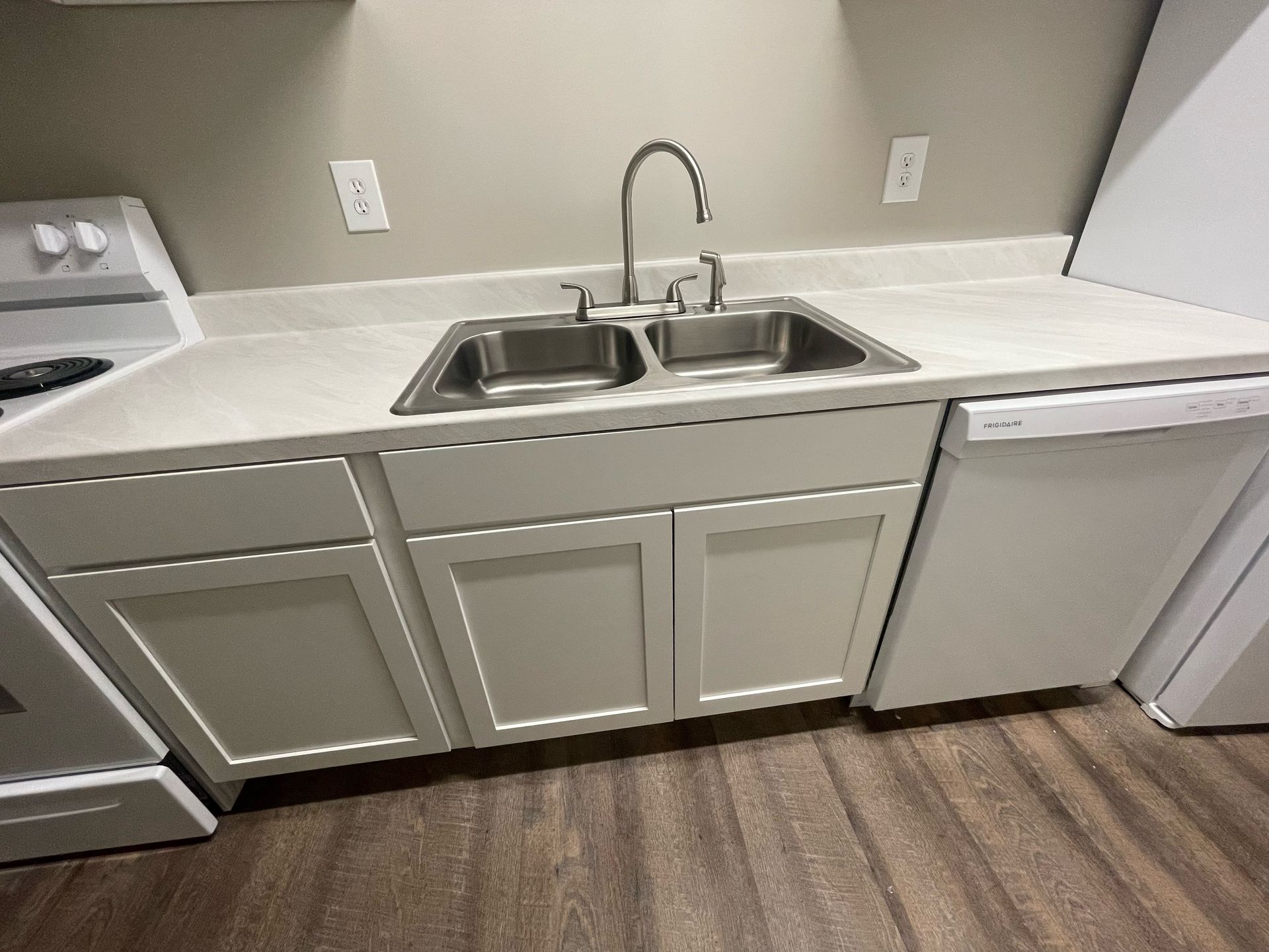 a kitchen with two sinks and a frigidaire dishwasher