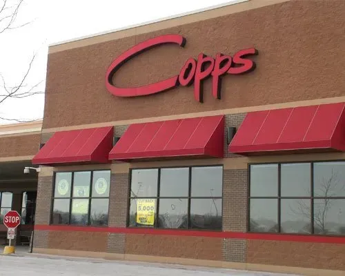 The outside of a copps store with red awnings