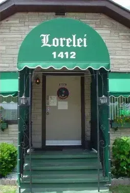 A house with a green awning that says lorelei 1412