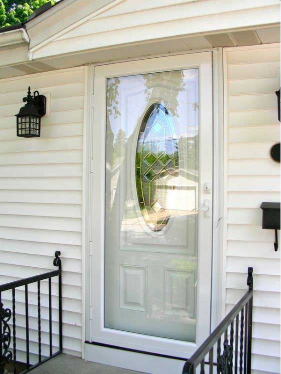 A white house with a glass door and a mailbox