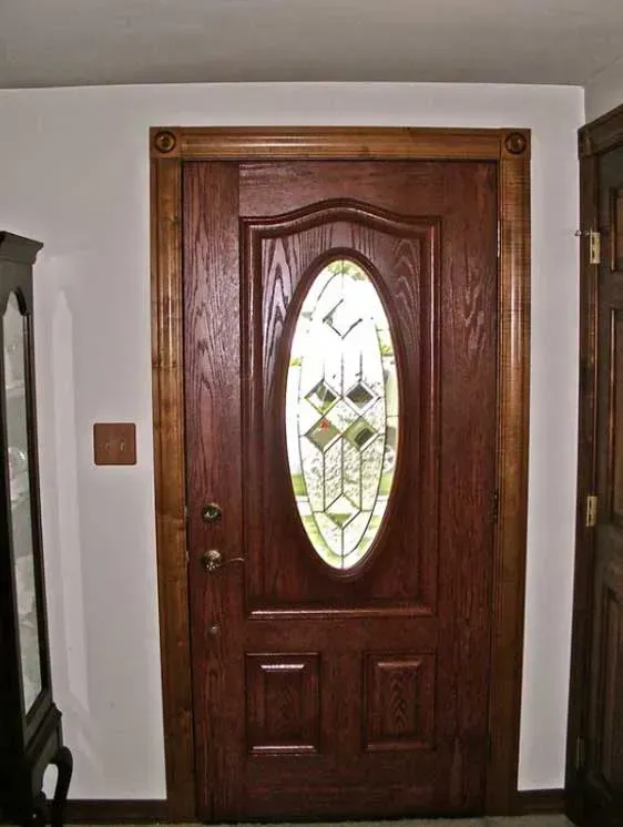 A wooden door with a stained glass window