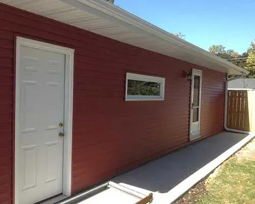A red house with a white door and window