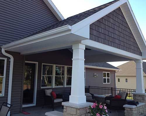 A house with a covered porch and patio furniture