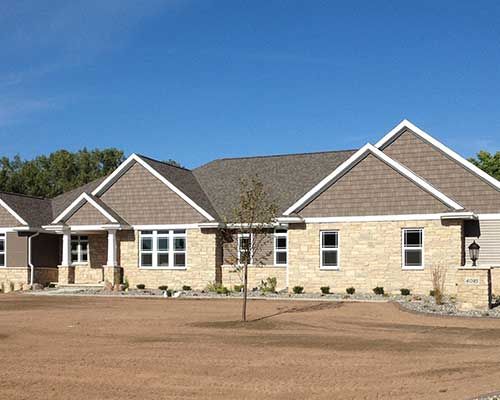 A large house with a tree in front of it