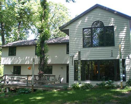 A house with a large deck and lots of windows