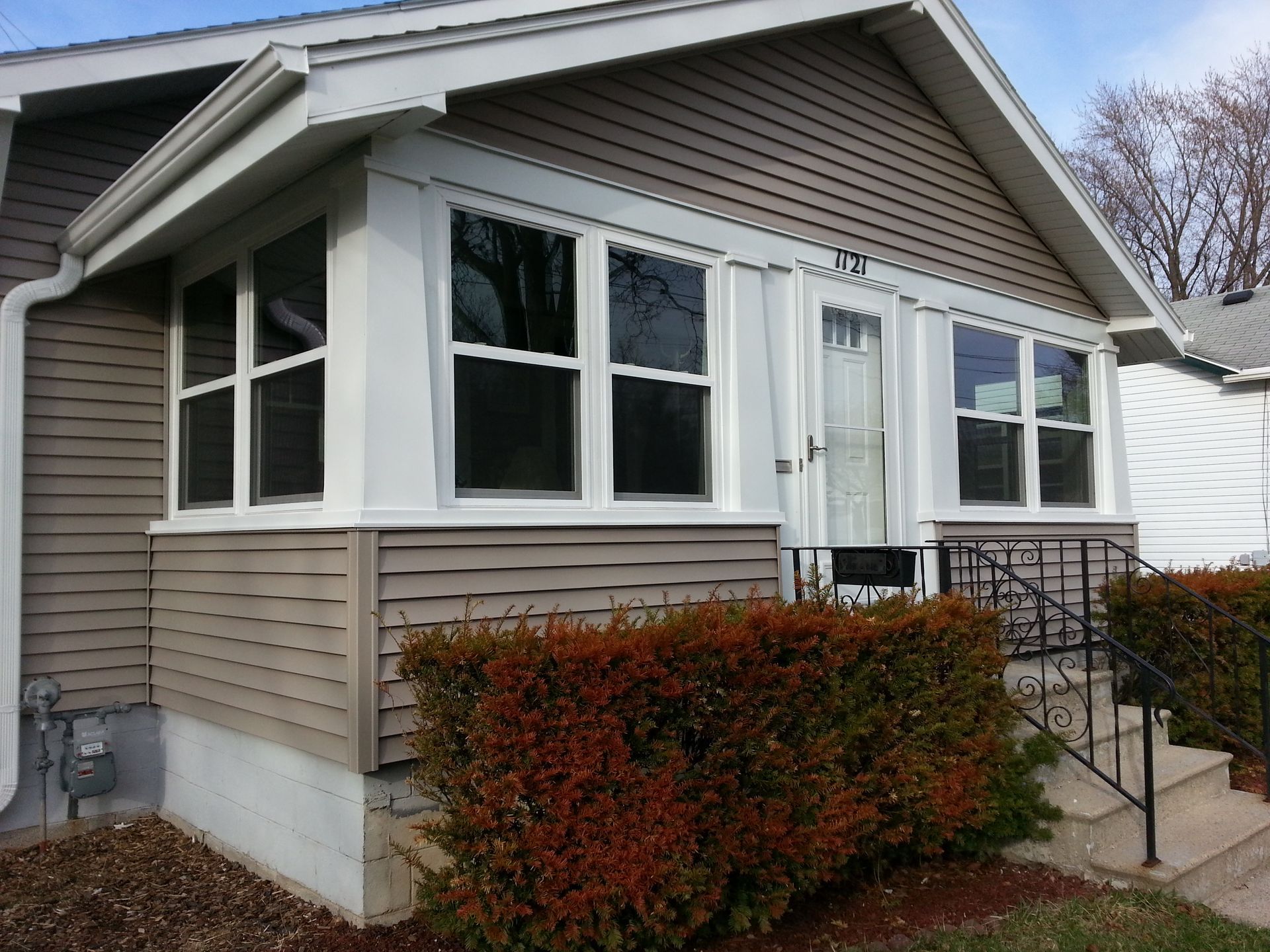 The front of a house with a porch and stairs