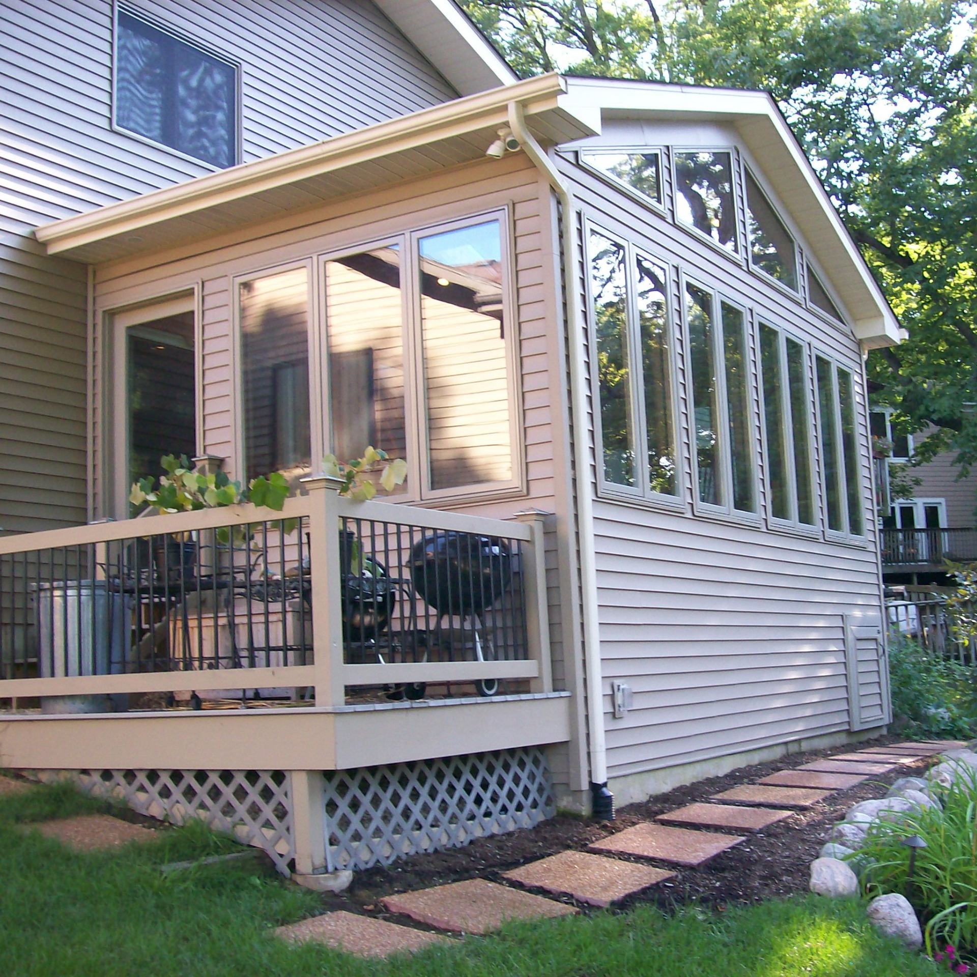 A house with a large porch and lots of windows