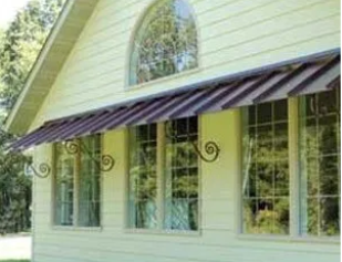 A white house with a purple awning over the windows.