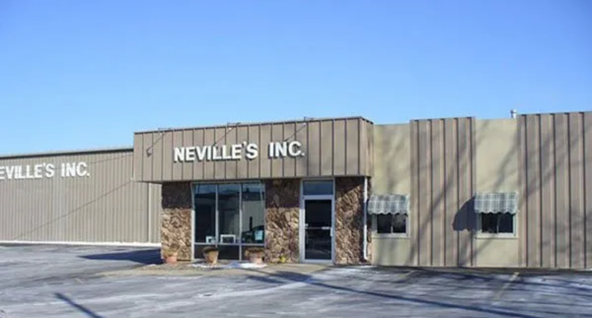 Neville 's inc. is a large building with a lot of windows.