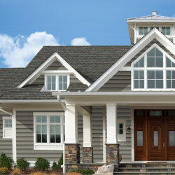A large house with a gray roof and white trim