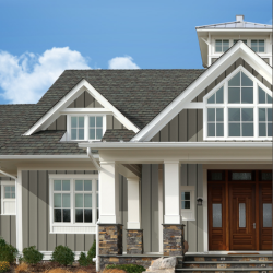A large house with a gray roof and white trim