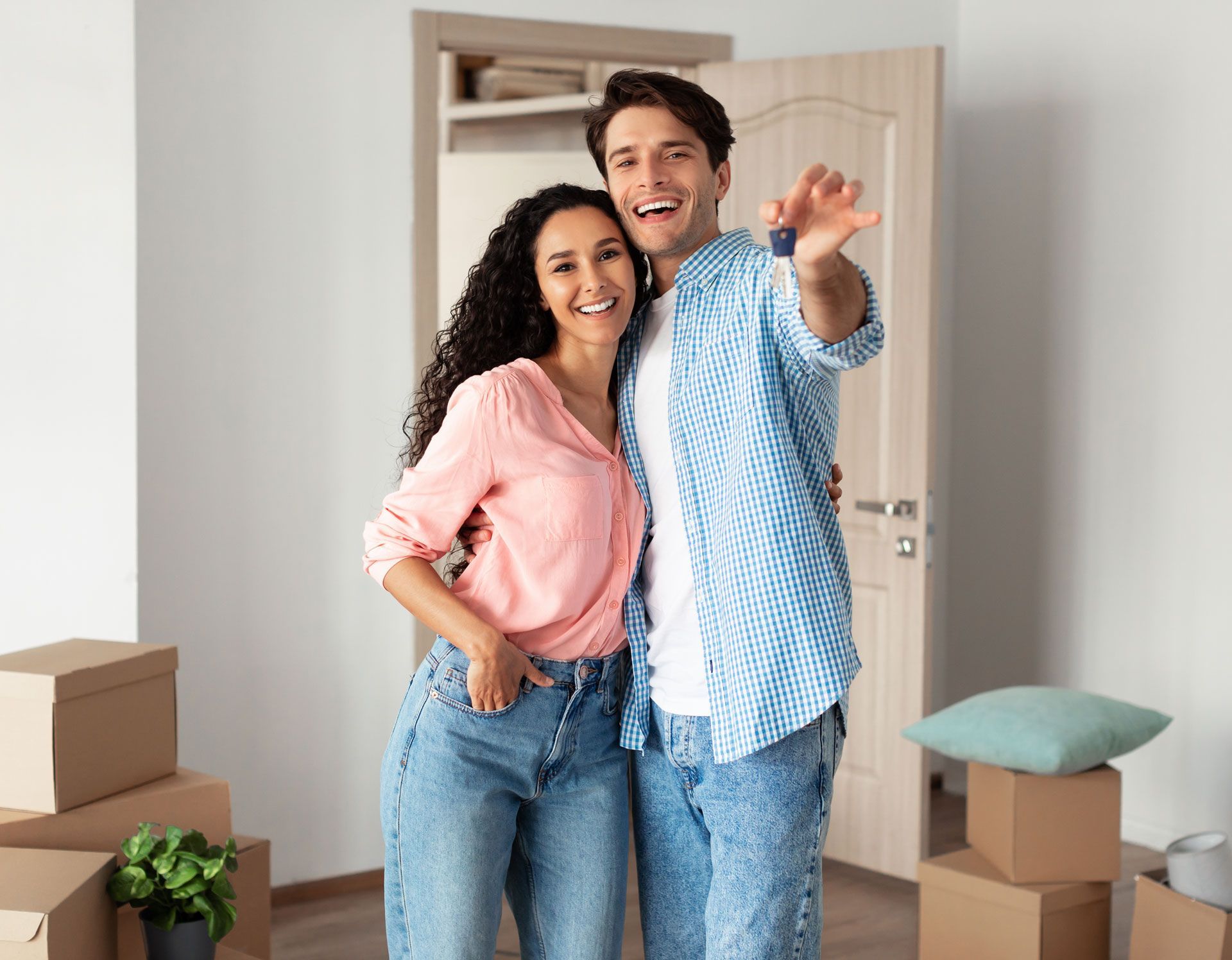 A man and a woman are posing for a picture in their new home.