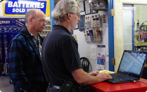 Two men looking at a laptop | BJ’s Automotive Diagnostic Center
