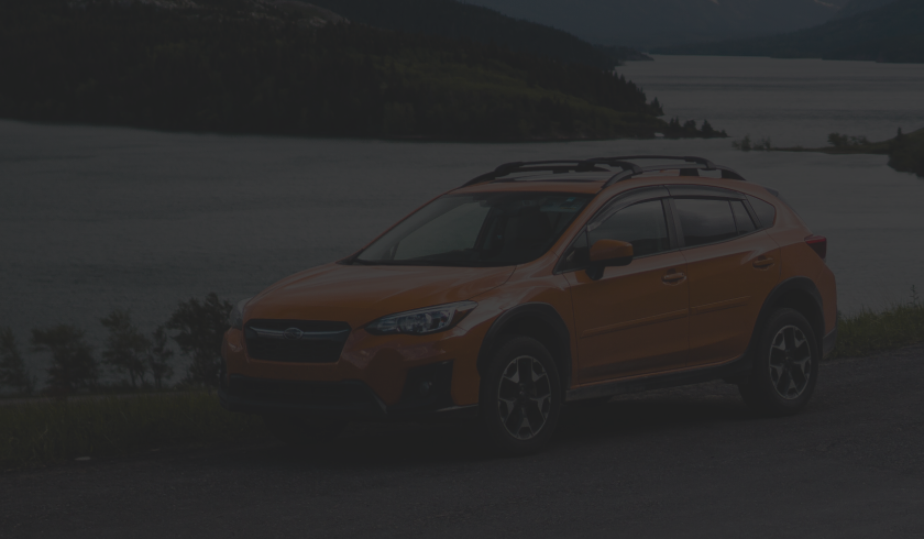 A Subaru SUV is parked in front of a lake | BJ’s Automotive Diagnostic Center