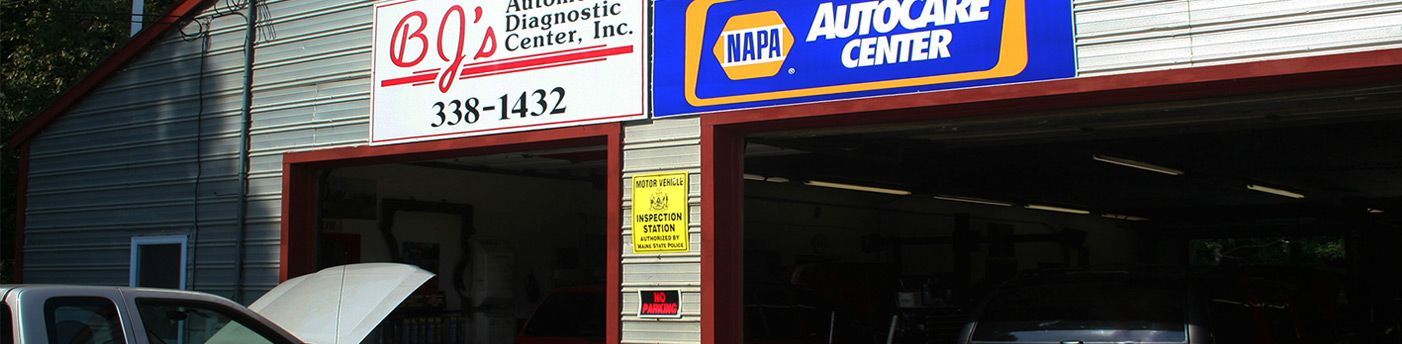 a white truck is parked in front of the shop | BJ's Automotive Diagnostic Center