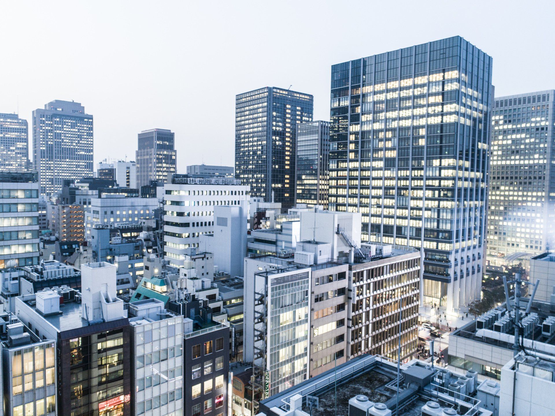 An aerial view of a city at night with lots of tall buildings.