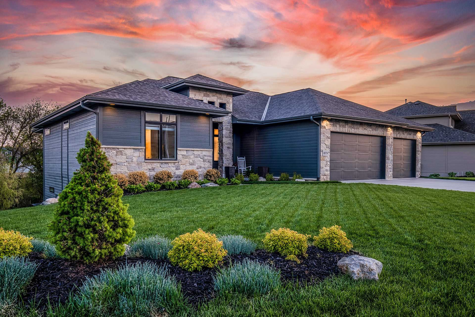 pink and purple sky and lush landscaping