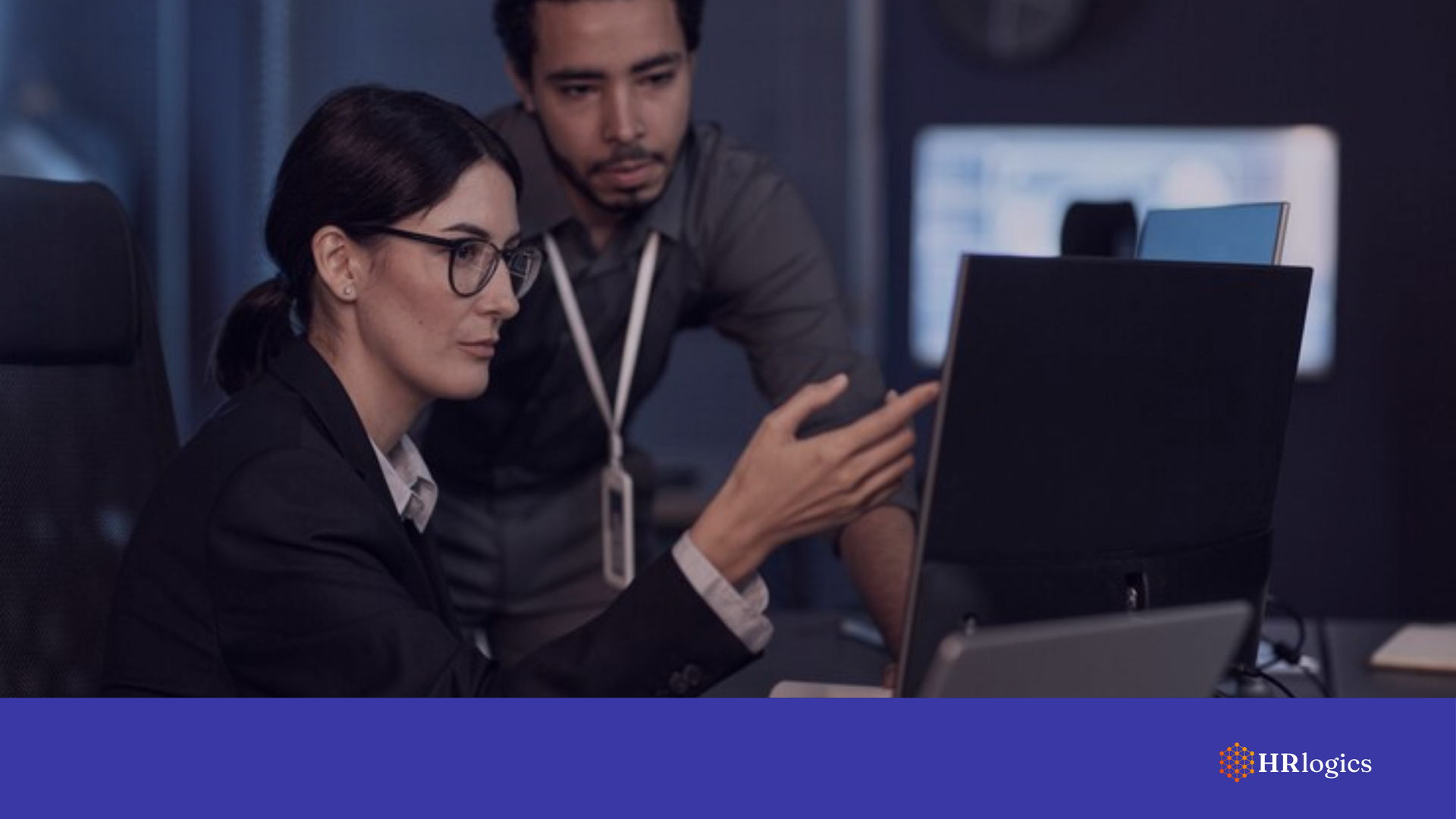 A cybersecurity specialist and an HR manager reviewing a 